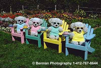 Teddy Bears lounging in a garden in their adirondak chairs sipping expresso.