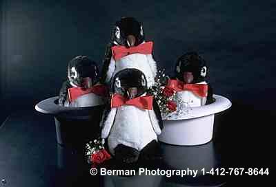Four Penguins in top hats. 