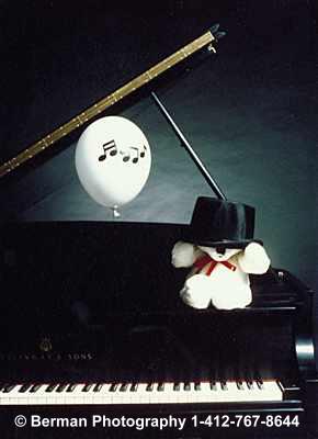 Teddy Bear musician at Carnegie Hall. Teddy in his top hat practicing the piano for his recital.