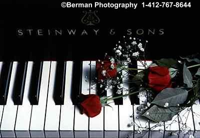 Steinway Piano with a bouquet of red roses. 